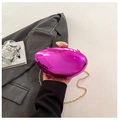 Detail of fuchsia metallic clutch bag with pebble clasp held over a grey blazer - Purple
