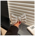 Macro detail of a 3D silver bow clutch bag with metallic mirror finish and thin chain - Silver Thin Chain Style