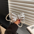 Chic silver bow-shaped evening bag with pearl handle and metallic mirror finish - Silver With Pearl Chain