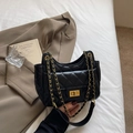Black quilted shoulder bag with gold chain strap and turn-lock detail on white background - One Size / Black