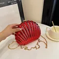 Chic red shell-shaped evening clutch bag with metallic finish and gold chain strap - Red