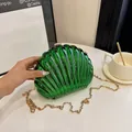 Emerald green shell-shaped evening bag with a metallic mirror finish and gold chain - Green