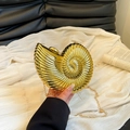 Fashionable gold nautilus shell clutch bag with spiral texture and chain strap - Gold