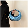 Detail of an electric blue metallic acrylic handbag featuring a unique pebble shape - Large Tote Style / Blue