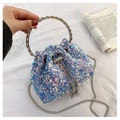 Close-up of sparkling blue sequined bucket bag with silver handles and chain strap - Blue
