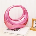 Detailed view of the glossy gradient pink acrylic handle bag on a minimalist background - Pink