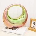 Iridescent circular ceramic vase with gradient metallic finish on art book decor - Multicolor