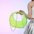 Neon green crescent acrylic evening bag with silver chain worn by a model - Neon Green