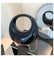 Detailed view of the glossy black crescent acrylic evening bag with silver chain strap - Black