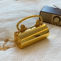 Elegant gold cylindrical evening bag with lion head handles and chain strap - Gold