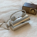 Silver mirror cylinder evening bag with metallic top handle and lion head details - Silver