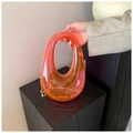 Neon orange acrylic evening bag with a hollow oval handle and gold metal chain strap - Pink