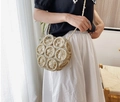 Detail view of beige circular woven hollow-out crossbody bag with cotton rope strap - Off White