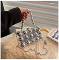 Detail of silver mirrored eggshell clutch with metallic studs and beaded handle - Silver