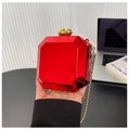 Detail of red acrylic octagon clutch bag with gold chain strap and bead clasp - Red