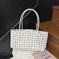 Detailed texture of white hand-woven tote bag with drawstring inner pouch and slim handles - White