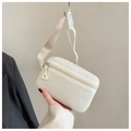 Detail of cream candy-colored kids fanny pack with dual zippers and adjustable strap - White