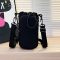 Versatile black water-resistant nylon crossbody phone bag with adjustable strap - Black