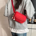 Kids red nylon fanny pack with triple zipper compartments and white triangular pulls - Red