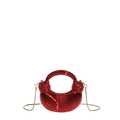Detailed view of red acrylic crescent mini bag with ribbed texture and gold chain strap - Red