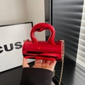 Glossy red metallic cylinder handbag with artistic twisted handle and gold chain strap - Red