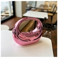 Detail of a pink metallic crescent bag with mirror finish on a white table - Pink Purple
