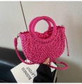 Detail of rose red straw woven handbag with drawstring inner and crossbody strap - Rose Red