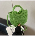 Detail of woven straw handbag in bright green with thick rope texture and drawstring closure - Green