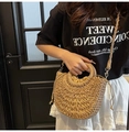 Detail of woven straw handbag with circular handles and drawstring lining for summer - Khaki