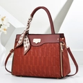 Detail of burgundy shoulder bag with woven texture, golden hardware and silk scarf handle - Burgundy