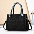 Detail of black tote bag with smooth matte finish and stylish floral silk scarf accessory - Black