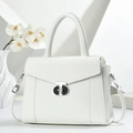 Elegant white lychee leather handbag with T-shaped rotating lock in a minimalist setting - White