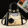 Chic black and gold shell crossbody bag with glossy patent leather finish and jewel clasp - Gold