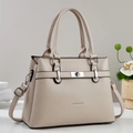 Close-up of cream lychee leather tote bag with silver twist lock and fashion logo - Khaki