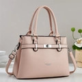 Pink lychee grain leather tote bag with silver buckle in a home setting close-up - Pink