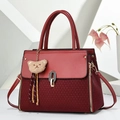 Large burgundy tote bag with woven texture, bear charm, and gold hardware details - Wine Red