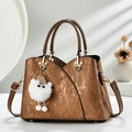 Vintage brown textured tote bag with golden buckle and plush pendant on clean background - Khaki/Earth Yellow