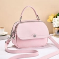Detail of light pink lychee pattern leather handbag with metal buckle and shoulder strap - Light Pink