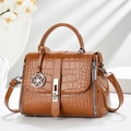 Detail of brown faux crocodile leather texture and silver rotating clasp on handbag - Khaki/Earth Yellow