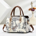 Women's beige paisley shoulder bag with brown handles and a gold floral pendant - Brown