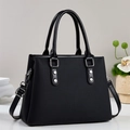 Classic black vintage tote bag with dual handles and silver rivets on a white surface - Black