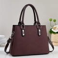 Elegant trapezoid brown leather handbag with silver metallic studs and crossbody strap - Coffee