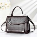 Elegant burgundy crocodile-embossed patent leather handbag with silver clover charm - Brown