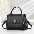 Close-up of black lychee grain leather bag with silver rivets and metal chain detail - Black