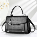 Elegant black faux crocodile leather handbag with silver flower pendant and metal corners - Black