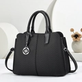 Black women's large tote bag with chevron texture and silver pendant detail for daily use - Black
