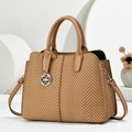 Detail of straw woven handbag with brown herringbone pattern and silver clover charm - Khaki