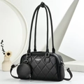 Detail of black quilted tote bag with silver hardware and small round coin purse charm - Black