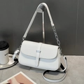Close-up of white crossbody bag featuring woven texture flap and silver metal buckle - White