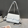 Elegant white crossbody bag with textured flap and silver oval buckle on metal stand - White